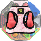A collage of EcoBark step-in dog harnesses in various patterns including French Floral in the foreground and  Red Buffalo Plaid, Cheetah print, and rainbow Tie Dye, in the back showing the variety of designer styles available.