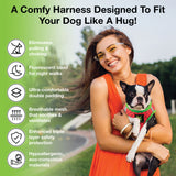 A woman smiling and holding a small black and white dog wearing an EcoBark watermelon step-in dog harness. Text highlights features: eliminates pulling & choking, fluorescent band for night walks, ultra-comfortable double padding, breathable mesh, triple layer safety protection, and hypoallergenic eco-friendly materials.